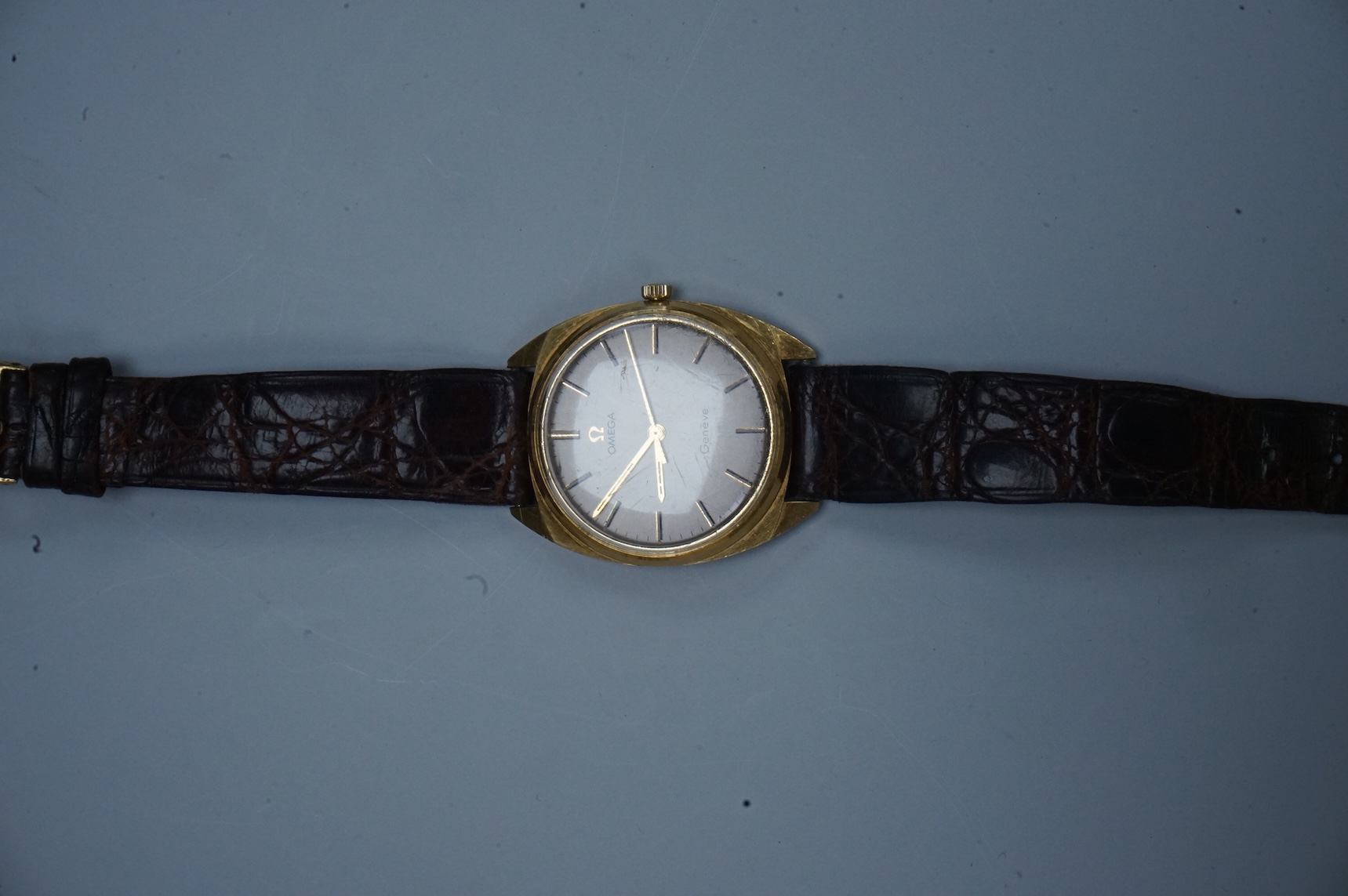 A gentleman's early 1970's 18ct gold Omega manual wind wrist watch, with baton numerals, case diameter 35mm, movement c.601, on a leather strap with gold plated buckle, no box or papers.